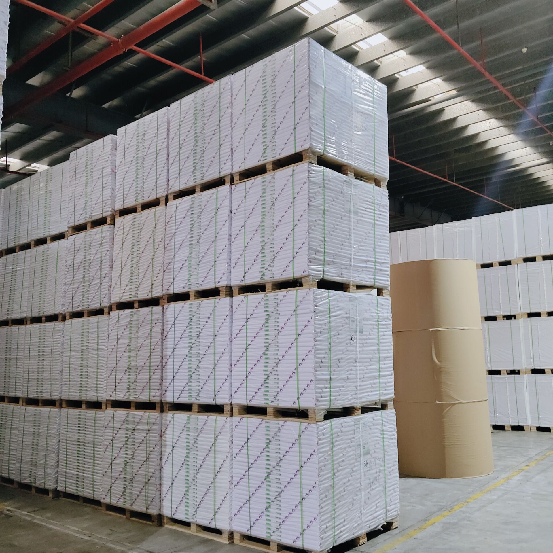 Wrapped paperboard pallets stacked in a YoungSun supply warehouse
