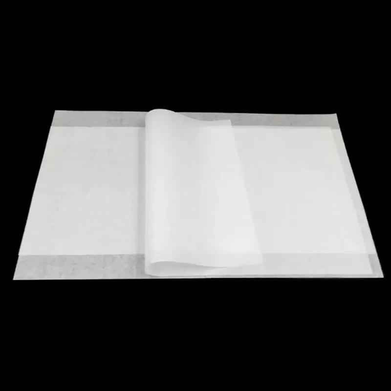 White greaseproof paper sheets displayed for food wrapping evaluation